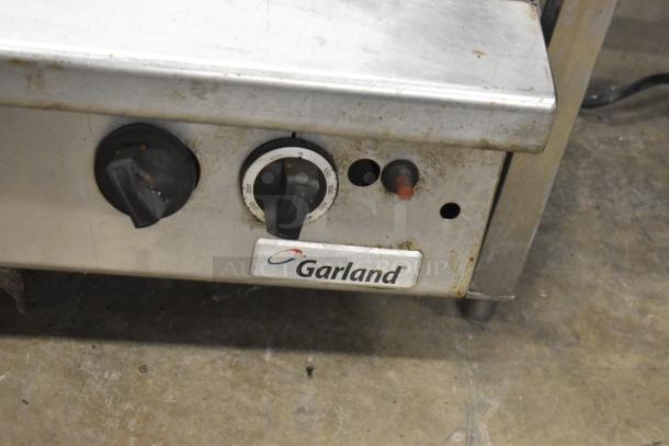 Garland Commercial Countertop Gas Charbroiler with control knobs and label, in used condition.
