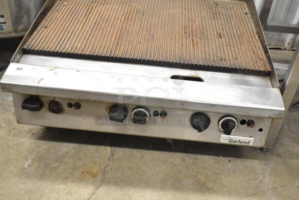 Garland Commercial Gas Charbroiler, countertop model, visible dials, worn surface, stainless build, Garland logo displayed.