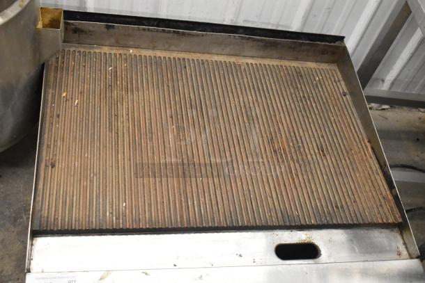 Garland commercial countertop gas charbroiler with ribbed grill plates. Used condition with visible wear and residue.