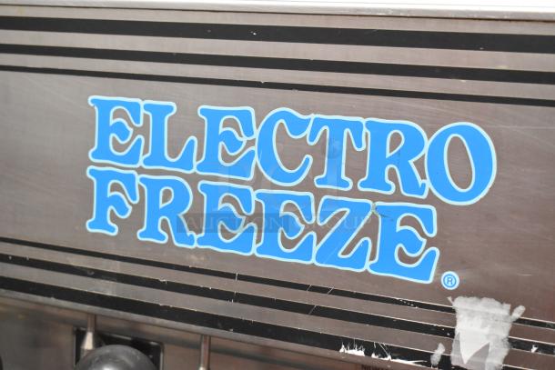 Electro Freeze 56TF-232 soft serve ice cream machine with two flavors and twist option, on commercial casters. Visible branding.