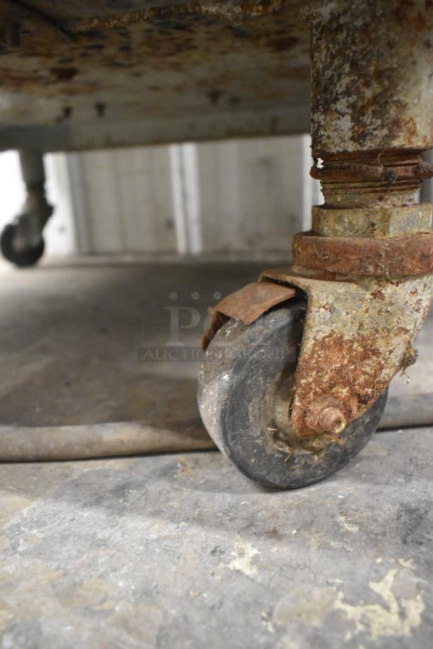 Rusted caster wheel of Electro Freeze 56TF-232 soft serve ice cream machine, showing wear and corrosion.