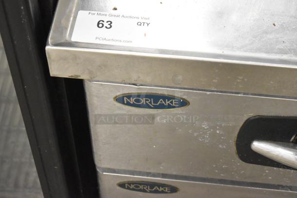 Norlake commercial 4-drawer chef base on casters, stainless steel, visible brand logo and auction label, 115 volts, 1 phase.