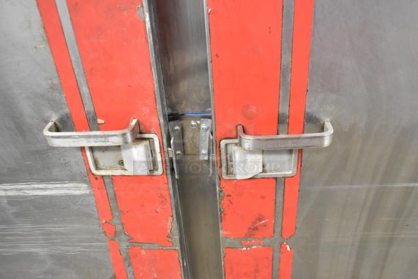 Carter Hoffmann BB1000 heated holding cabinet with metal doors, visible wear, and latches. Features red accents and commercial casters.