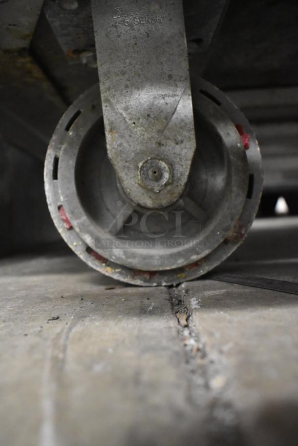 Close-up of a caster wheel on a Carter Hoffmann BB1000 heated holding cabinet, showing signs of wear.
