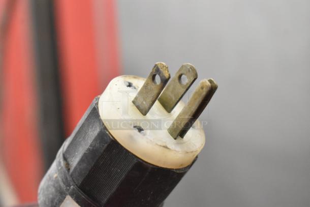 Close-up of a worn plug from the Carter Hoffmann BB1000 Heated Holding Cabinet, showing three prongs and signs of use.