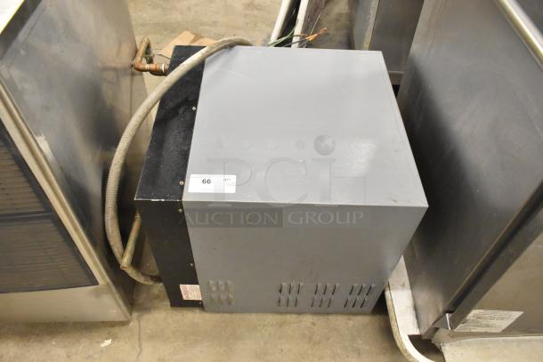 Hatco Imperial Series commercial hot water booster heater; grey and black casing, visible piping, item tag "66" attached.