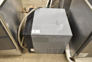 Hatco Imperial Series commercial hot water booster heater; grey and black casing, visible piping, item tag "66" attached.