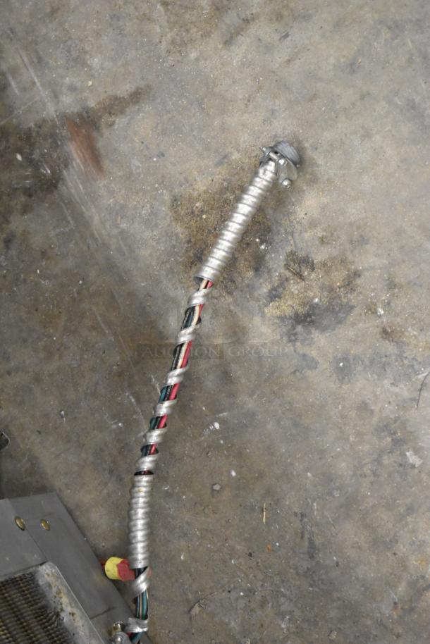 Coiled wiring conduit connected to a Hoshizaki KM-900MAH Commercial Ice Head, showing electrical components.