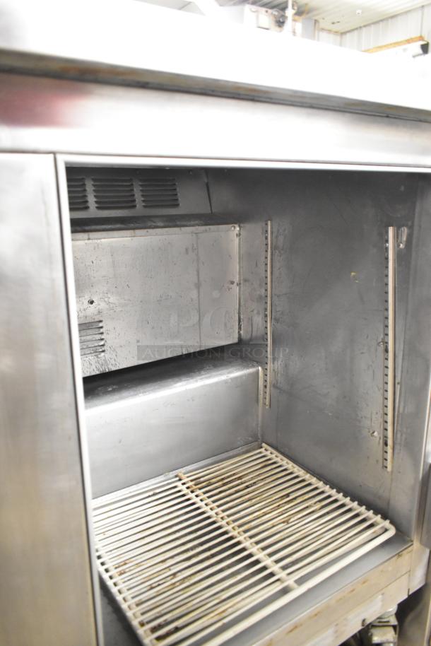Beverage Air SUR48-12 prep table on casters, stainless steel, 115V, 1 phase, spacious interior, well-maintained, commercial use.