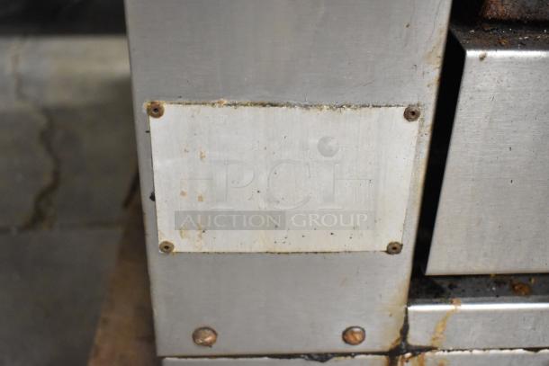 C-45 Commercial Cheese Melter in used condition, natural gas powered, 42,000 BTU, stainless steel exterior with visible wear.