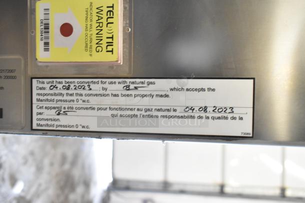 Brand new 2023 Henny Penny FPGM22172007 stainless steel natural gas convection oven with pan rack, 200,000 BTU. Labels show gas conversion date: 04.08.2023.