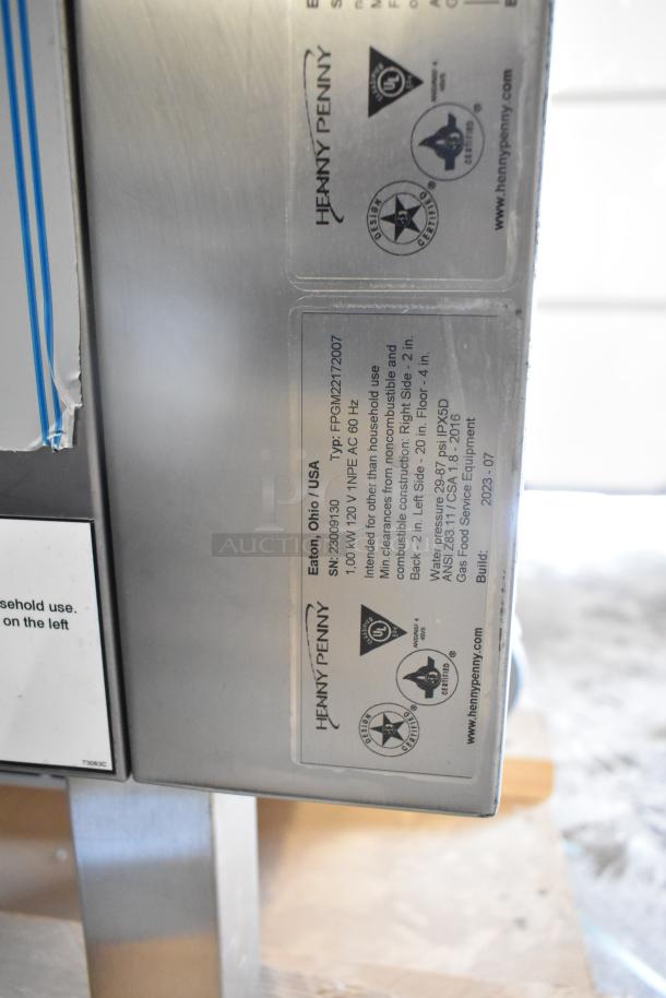 Brand new 2023 Henny Penny FPGM22172007 stainless steel natural gas combi convection oven; model and certification labels visible.