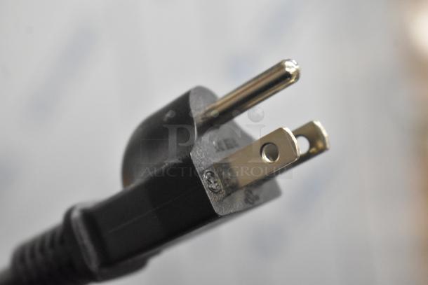 Close-up image of a power plug for the Galaxy 177GRCS60 rice cooker, showing standard prongs and grounding pin.