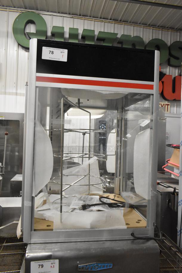 Hatco FSDT-2 Flav-R-Savor display cabinet with four-tier circle rack, glass doors, 120 volts, 1 phase, auction tag visible.