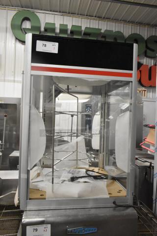 Hatco FSDT-2 Flav-R-Savor display cabinet with four-tier circle rack, glass doors, 120 volts, 1 phase, auction tag visible.