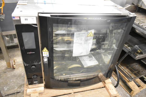 Brand new 2022 Alto Shaam AR-7T electric rotisserie oven, 7 spit, 380-415V, 1 phase, USA-made, with safety labels.