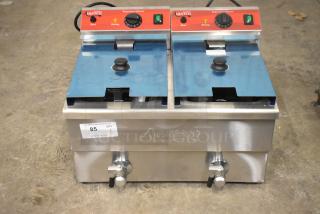 Brand new Avantco 177F202 30 lb. dual tank electric fryer with two metal lids and fry baskets, 208-240V, seen with labels.