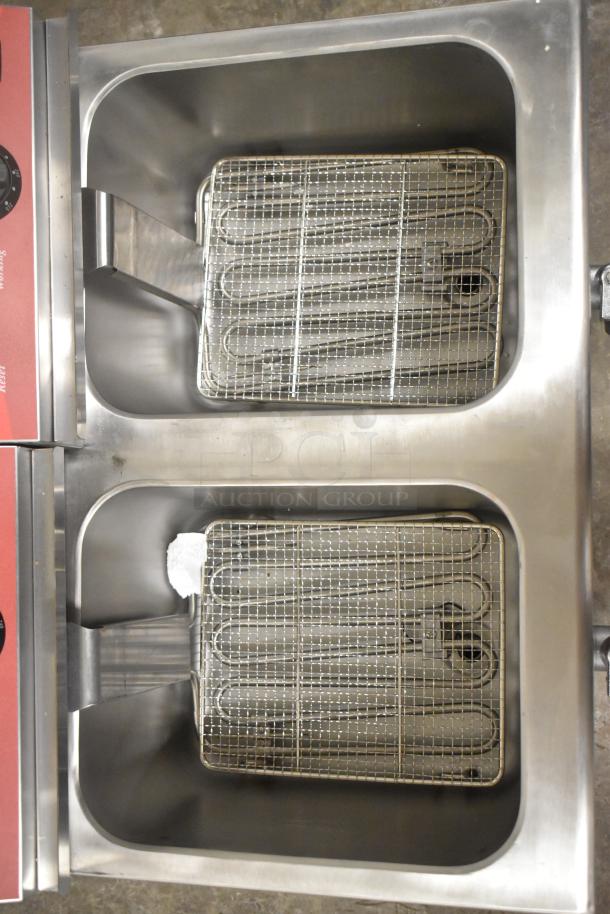 Brand new Avantco 177F202 dual tank electric fryer, 30 lb capacity, includes 2 metal lids and baskets, 208-240V, 1 phase.