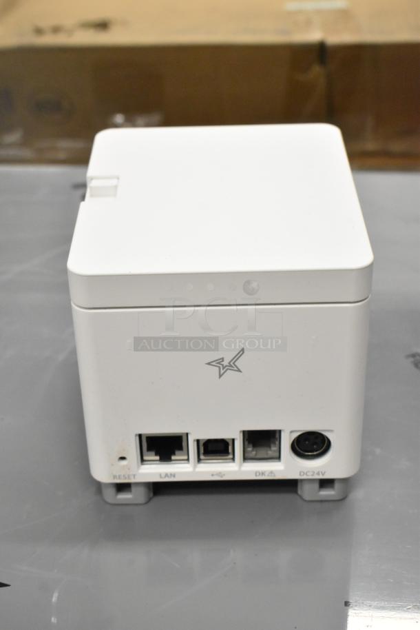 Brand new C-Print MCP20 WT US receipt printer, scratch and dent condition. Features LAN, USB ports, and DC24V input.