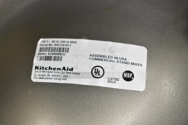 KitchenAid KSM8990CU mixer label showing model, serial number, voltage info, UL, NSF certifications, and assembly location.