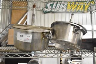 Two metal popcorn kettles on a shelf, labeled "98 QTY XL," used, for popcorn machines.