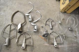 11 mixer attachments: pastry, 4 paddles, 3 dough hooks, 3 whisks, metal, varied condition. Auction item, number label visible.