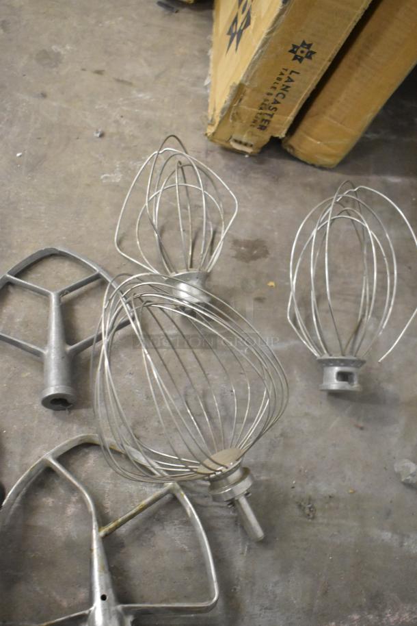 11 mixer attachments, including pastry, 4 paddles, 3 dough hooks, and 3 whisks, shown in used condition.