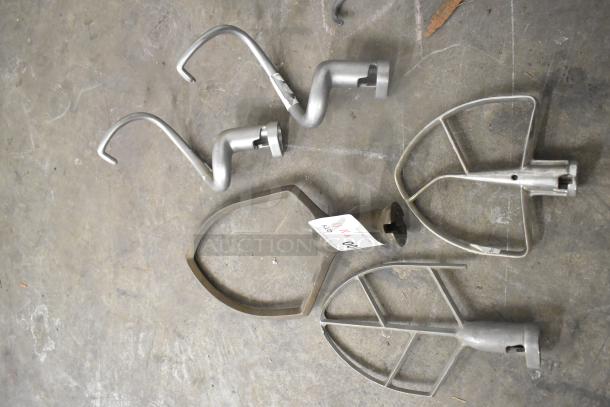 11 mixer attachments including 1 pastry, 4 paddles, 3 dough hooks, 3 whisks; auction lot tag visible.