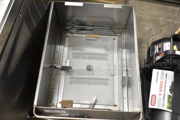 Brand new scratch and dent oil grease trap with Frymaster 1080437 Flue Assy, Gf14. Includes intact mesh and metal components.