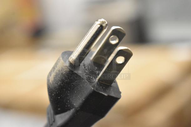 Close-up of a plug for a Vita-Mix VM0214 blender, showing standard three-prong connector.