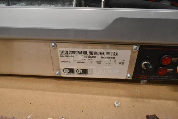 Hatco GRHD-4PD Dual Shelf Merchandiser, white granite stainless steel, 58 1/2", 120/208 volts, with glass damage visible.