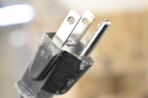 Close-up of a slightly dusty plug for the Galaxy MDT4 Light-Duty 4-Slice Commercial Toaster, 120 Volts, 1 Phase.