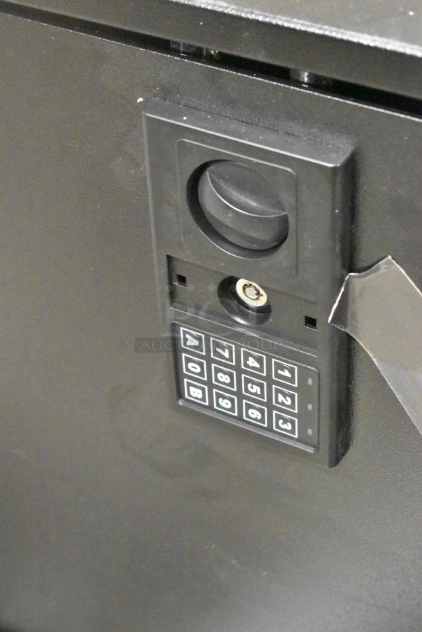 Black steel 700 key cabinet safe, 23" x 13" x 29.75", brand new with minor scratches, features electronic keypad lock.
