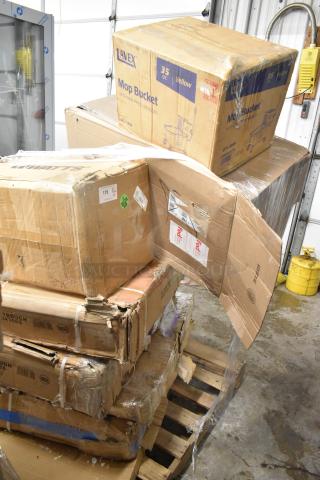 Stack of boxes containing brand new commercial items including Regency Stainless Steel Work Table, Watts Grease Interceptor, and Hatco Infrared Food Warmer. Boxes show signs of wear.
