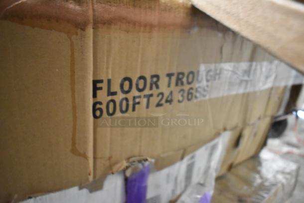 Cardboard box labeled "Floor Trough 600FT24 36SS" containing new Regency 24" x 36" stainless steel floor troughs.
