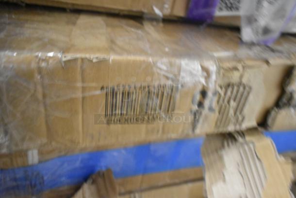 Blurred image of stacked cardboard boxes with visible barcodes, possibly containing a variety of new commercial kitchen equipment.