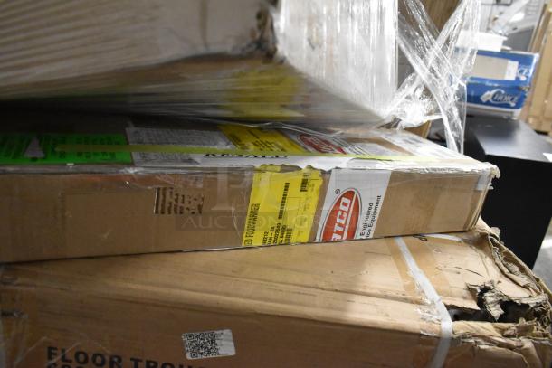 Boxes containing Hatco Glo-Ray Infrared Food Warmer, Regency stainless steel work tables, and floor troughs, showing labels and packaging.
