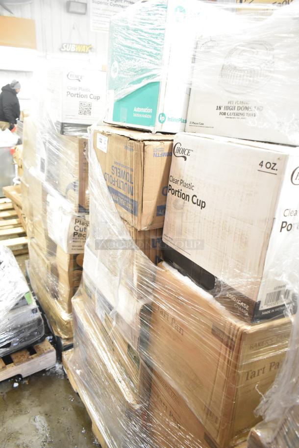 Pallet of 28 scratch and dent items, including Choice portion cups and multi-fold towels, wrapped in plastic for auction.
