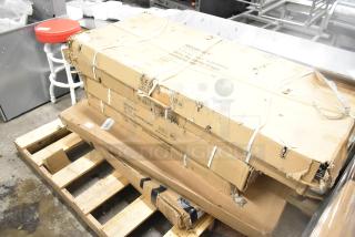 Cardboard boxes of Regency chrome wire shelves on a pallet, slight wear, labeled "25x48", six new scratch and dent items.