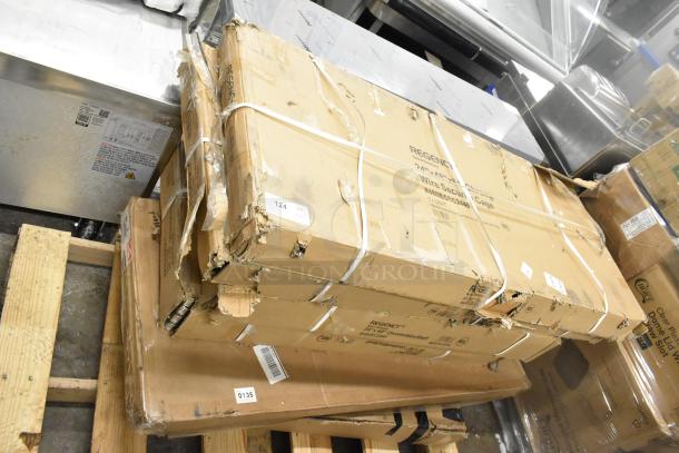 Stack of 6 brand new scratch and dent boxes on a wooden pallet, labeled with Regency brand shelving details.