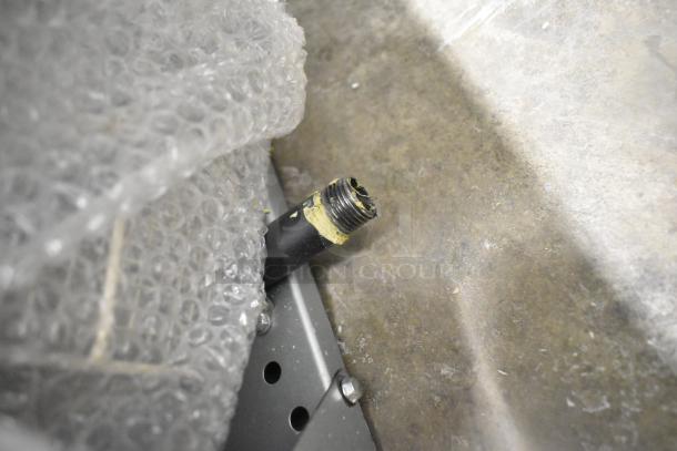 Alt text: Close-up of a new Avantco FF100 liquid propane floor fryer showing a threaded pipe connection and bubble wrap.