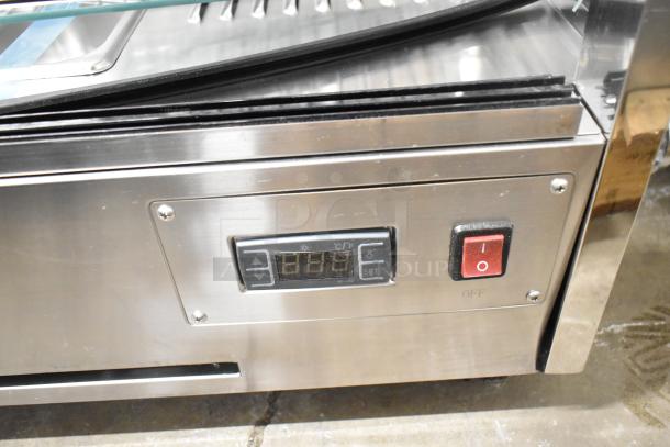 Brand new ServIt 423HDM26SA heated display case. Features digital controls and sliding doors. Note: broken glass visible.