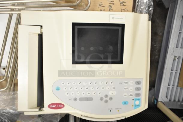 Marquette MAC1200 EKG Machine, display and control panel visible, excellent condition. Auction includes 12 various items.