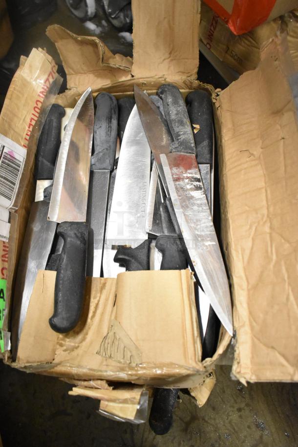 Box of 100 sharpened stainless steel knives, including chef and serrated types, with black handles and visible "Lasting Cut" branding.