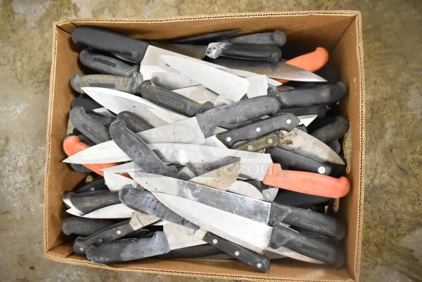 Box of 220 sharpened stainless steel knives, including chef knives, with black and red handles; varied conditions.