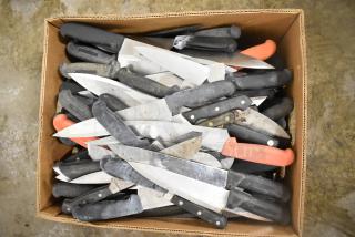 Box of 220 sharpened stainless steel knives, including chef knives, with black and red handles; varied conditions.