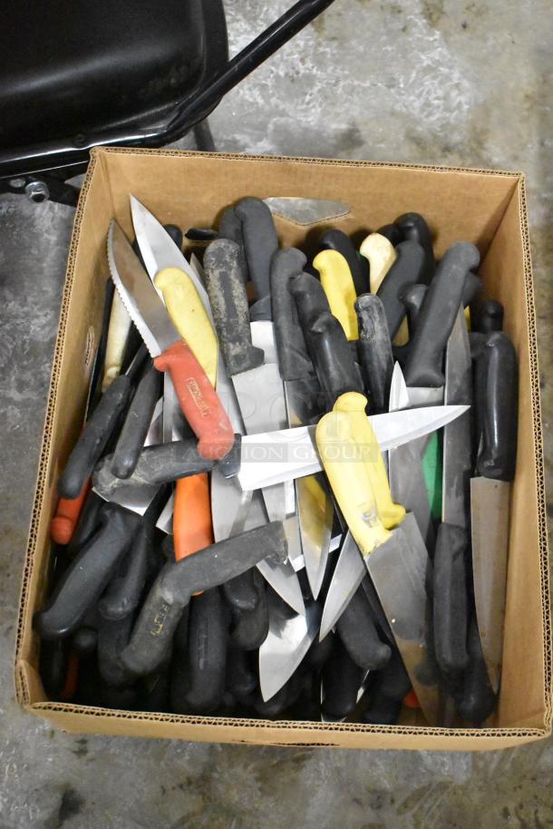 Box of 220 sharpened stainless steel knives, various handle colors, including chef knife. Mixed condition, ideal for bulk purchase.