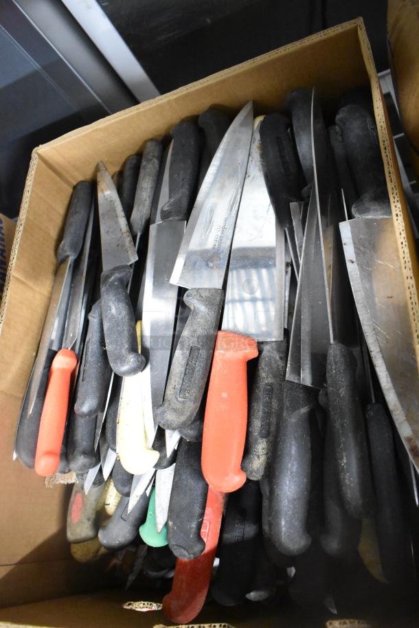 Collection of 150 sharpened stainless steel knives, including chef knives, with colored handles, in a box.