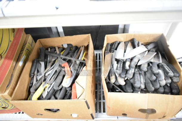 Two boxes containing 200 sharpened stainless steel knives, including chef and serrated knives with black handles.