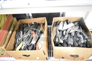 Two boxes containing 200 sharpened stainless steel knives, including chef and serrated knives with black handles.